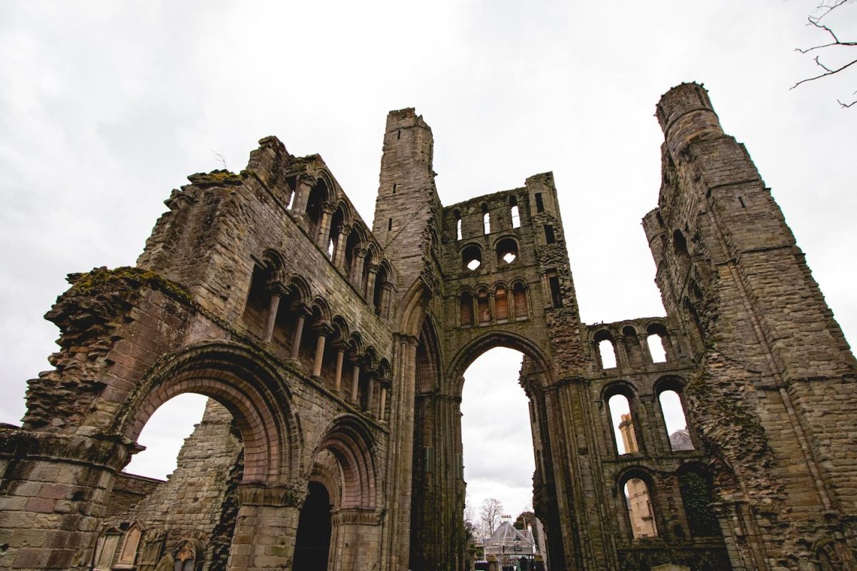 Ruins of an old stone church under a cloudy sky.