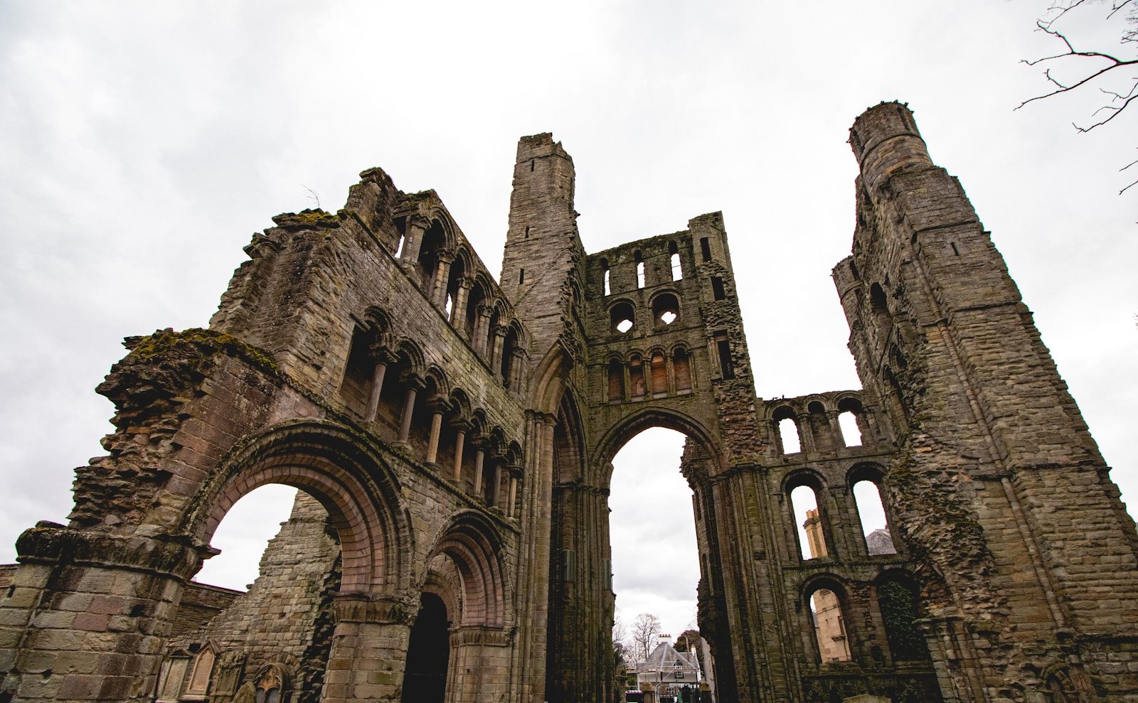 Ruins of an old stone church under a cloudy sky.